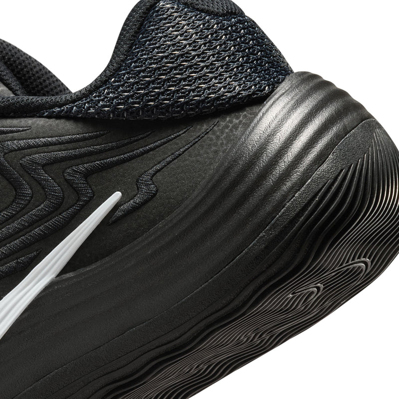 Men's black sneaker quarter panel close-up with white swoosh and ridged midsole