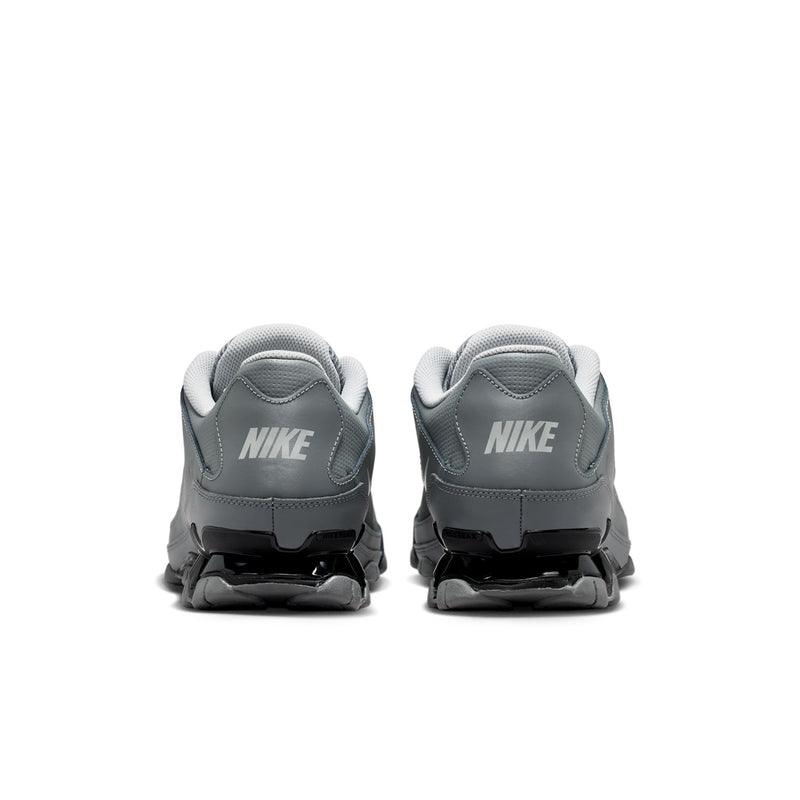 Men's training shoes heel view in smoke grey with black midsole accents and rear cushioning.