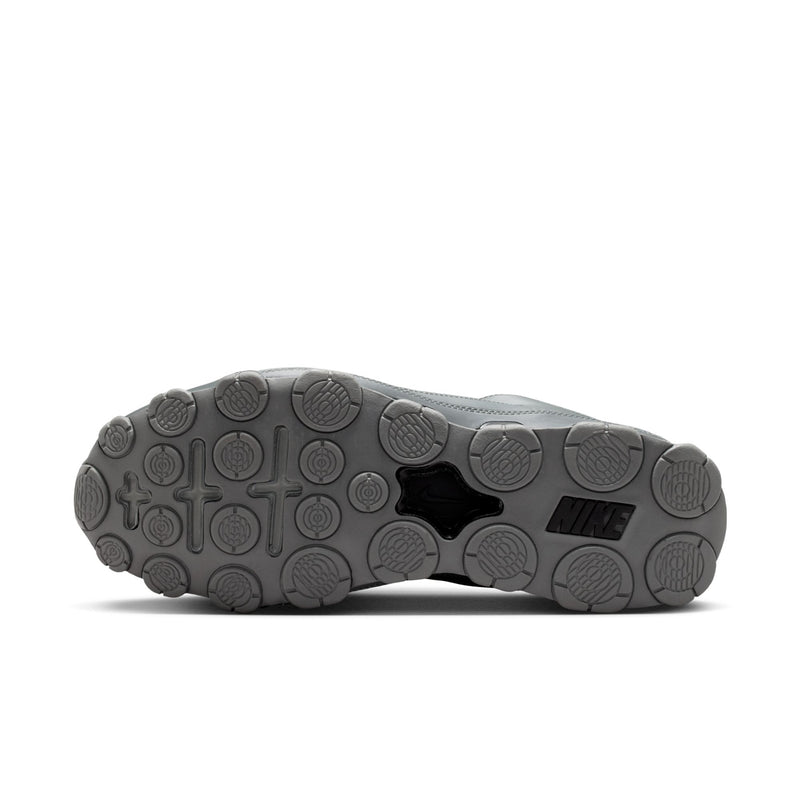 Men's training shoes outsole view with circular traction pods and dark rubber heel.