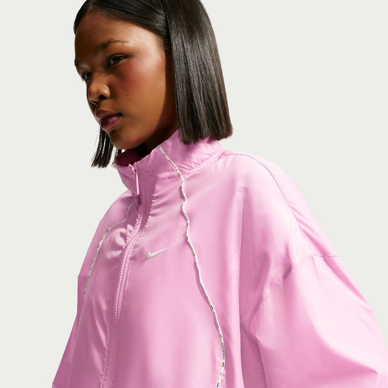 Women's pink windbreaker jacket with front zipper and reflective seam piping detail