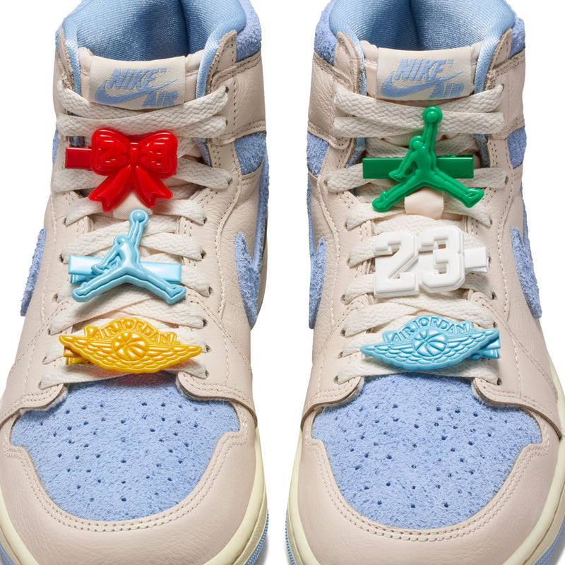 Close-up of high-top sneaker tongues with Air branding and colorful lace charms.