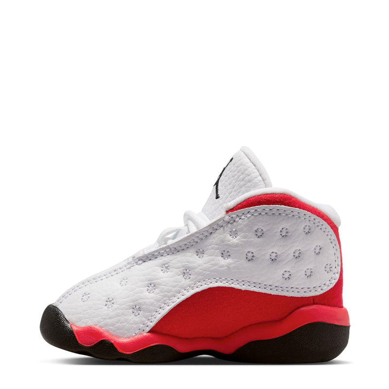 Toddler low-top sneaker, white perforated panels with red lining and black rubber sole.