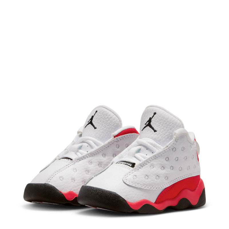 Toddler lace-up sneaker pair, white uppers with red heel trim and black outsole.