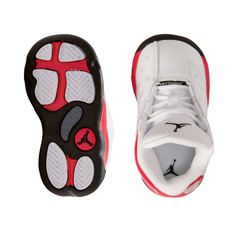 Toddler sneaker outsole and inside view, white upper with red trim and black rubber sole.