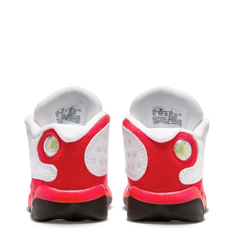 Toddler sneaker heel view, white upper with red back panels and black outsole.