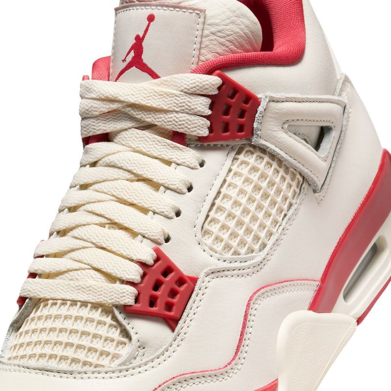 Close-up of women's retro sneakers: pale ivory laces, mesh overlay, and red midsole