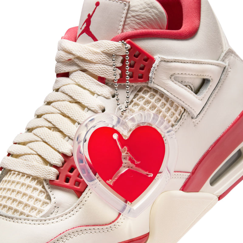 Close-up of women's retro sneakers with heart charm overlay and red grid detail