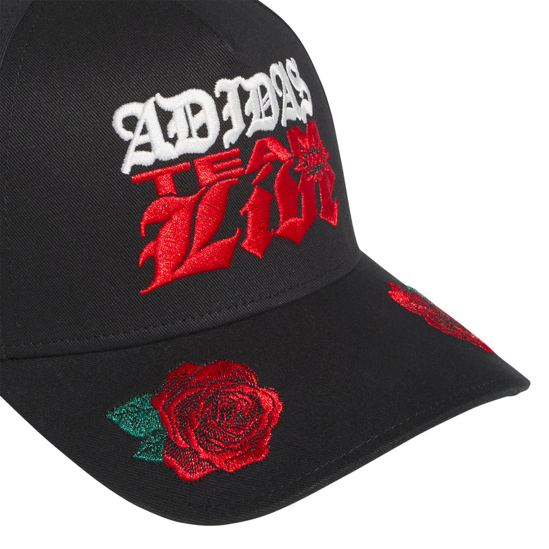Black snapback cap close-up with embroidered adidas graphic and rose patch