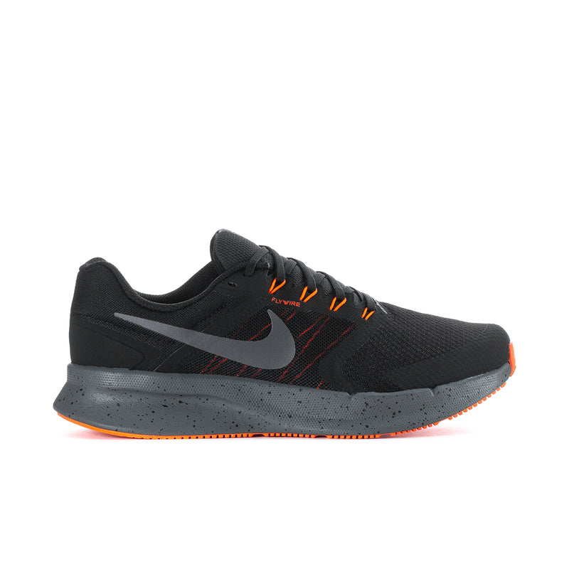 Black mesh running shoes with orange laces and Nike swoosh, cushioned midsole.