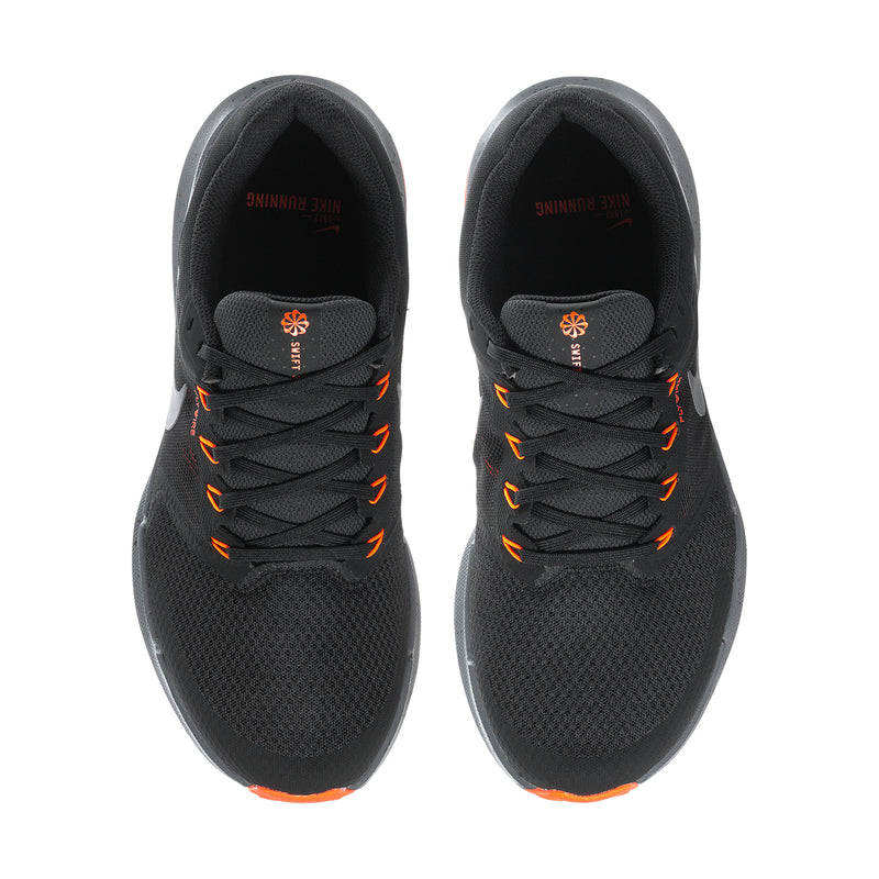 Black running shoes viewed from above, orange lace eyelets and interior padding.