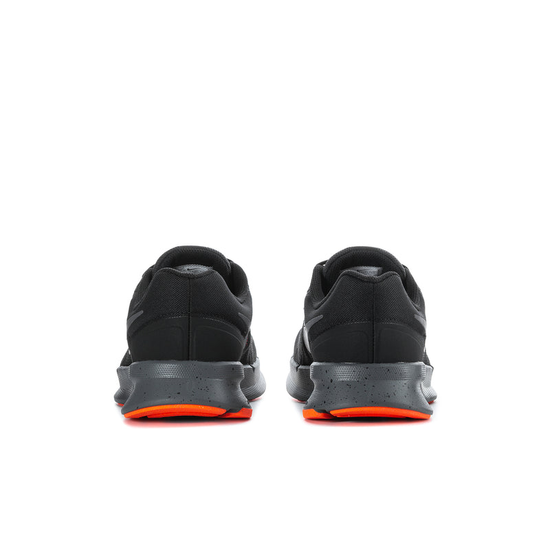 Black running shoes with orange-trim heel and cushioned sole, rear view.