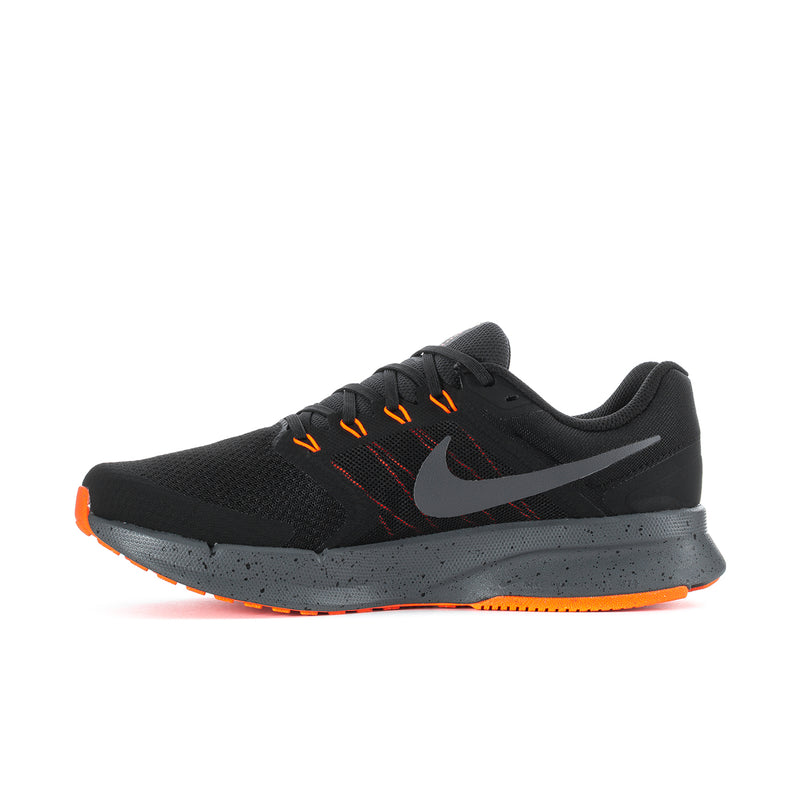 Black knit running shoe with Nike swoosh and orange lace details, side view.