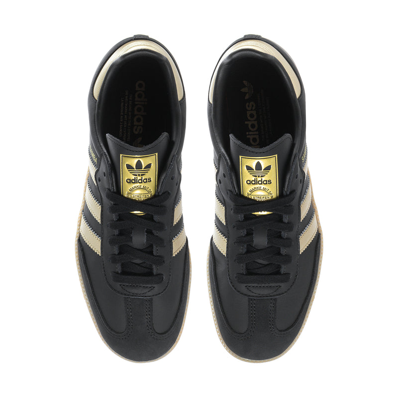 Samba OG women's sneakers laced top view, black with gold Adidas branding on tongue