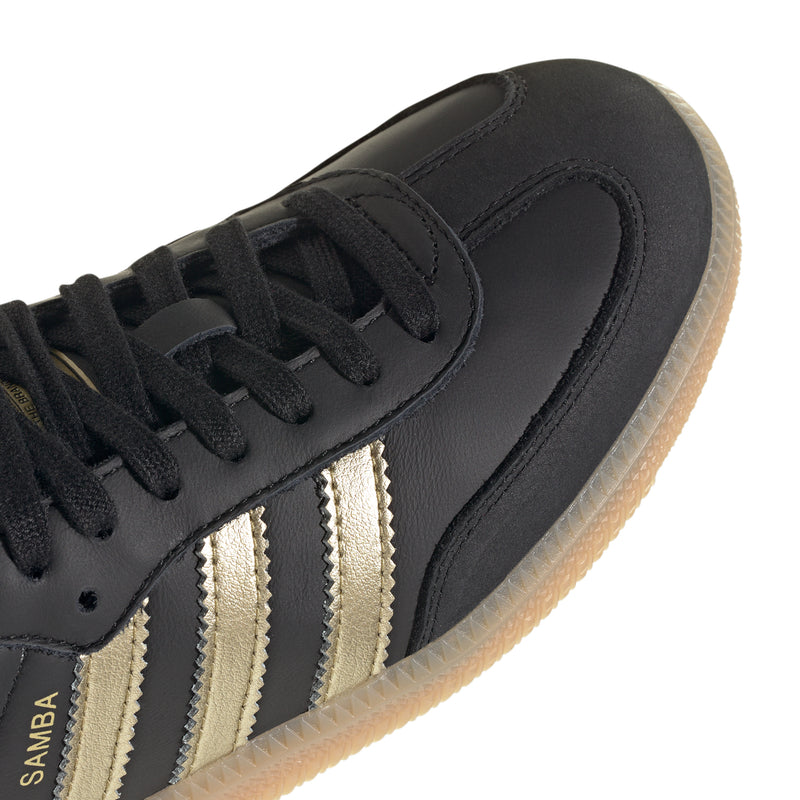 Samba OG women's sneaker toe and laces detail, black leather with gold stripe accents