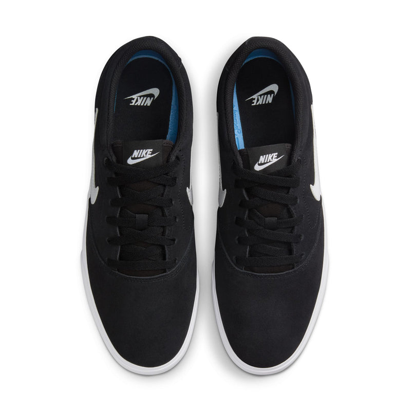 Men's black low-top skate sneakers with white outsole trim and blue-lined interior at tongue.