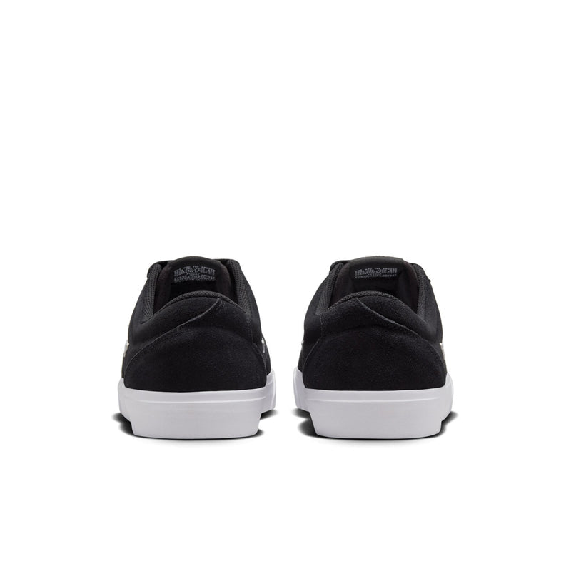 Men's black low-top skate sneaker, white midsole, rear view with logo text at heel.