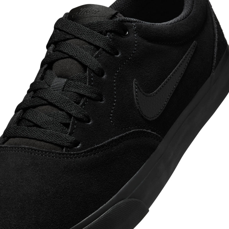 Close-up of black lace-up sneaker upper with embroidered Nike Swoosh and stitching.