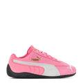 Youth pink and white Puma sneakers with black sole, lace-up design and PUMA logo.