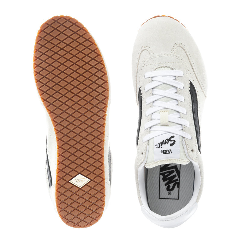 Women's low-top sneaker outsole and side view, off-white upper, gum tread sole