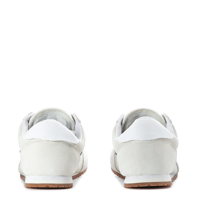 Women's low-top off-white sneakers with heel tab and gum outsole, rear view