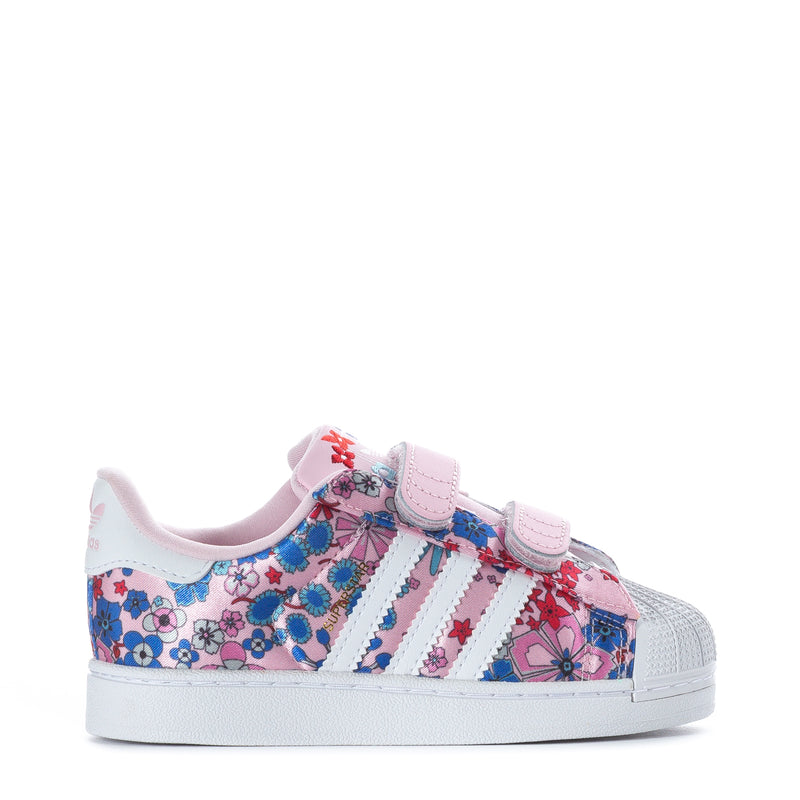 Toddler low-top sneakers with colorful floral print and pink hook-and-loop strap.