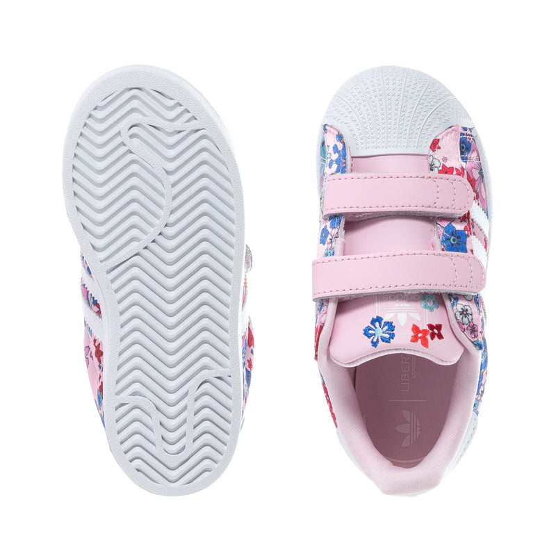 Toddler sneakers: white outsoles with zigzag tread and pink floral side panel.