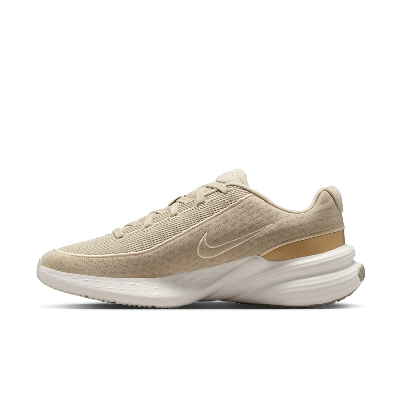 Beige men's running shoe with Nike swoosh, lace-up upper, and white sole.