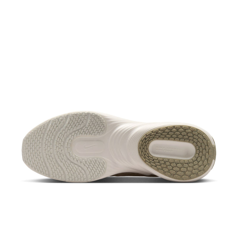 Beige and white shoe outsole with textured tread pods for grip.