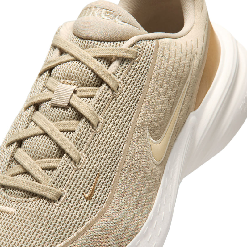 Beige knit upper lace-up running shoe with Nike swoosh detail.