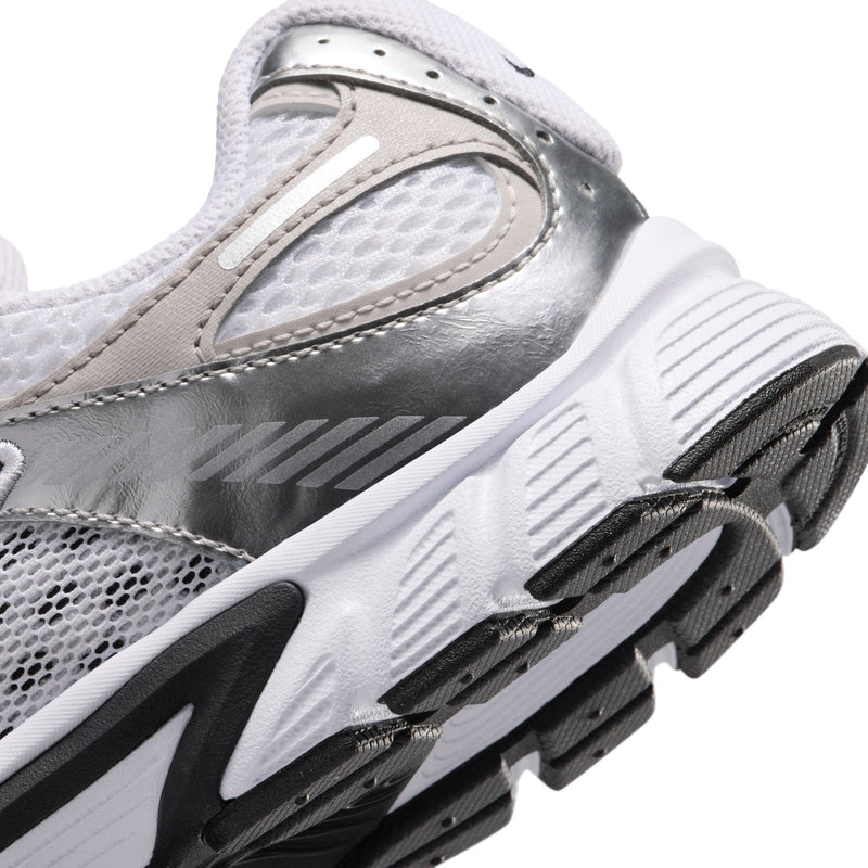 Close-up side view of youth sneaker midsole and outsole with black accent trim