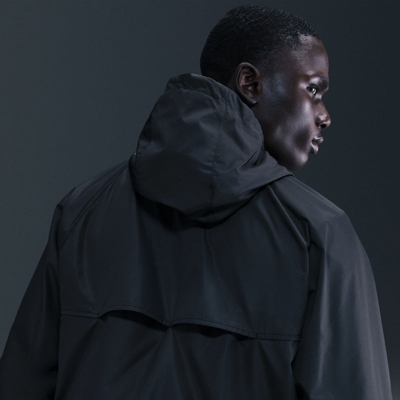 Men's black hooded windbreaker jacket close-up showing hood and shoulder seams