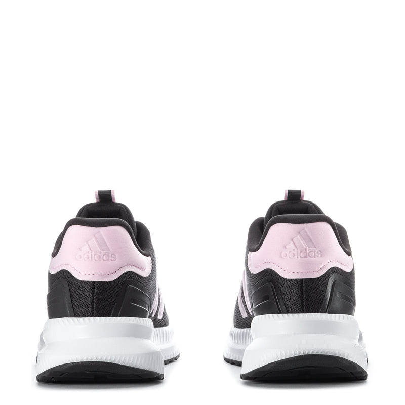 Women’s black sneakers from heel view with pink logo tab and white cushioned midsole