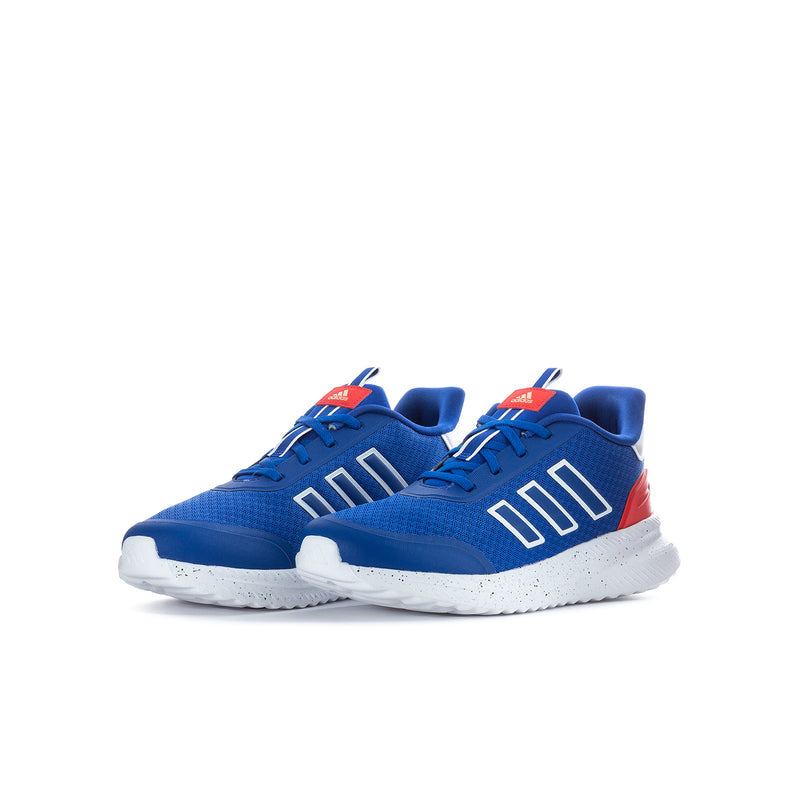 Youth sneakers pair in blue with white sole, red heel accents, striped side logo.